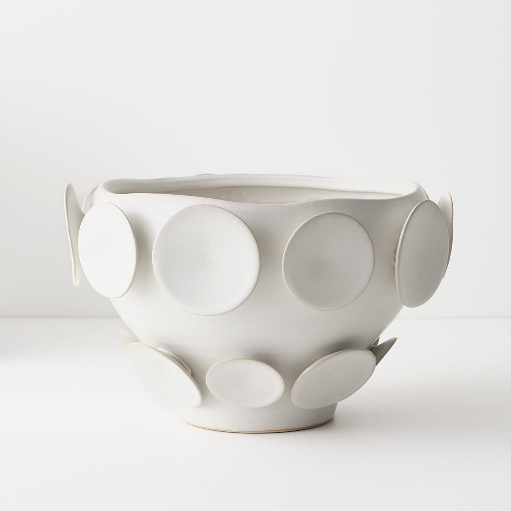 White ceramic bowl with circular patterns 