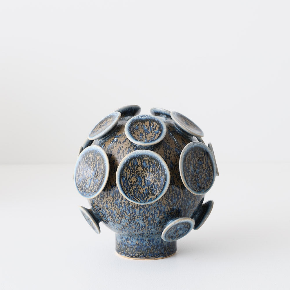 Blue ceramic vase with circular design on 