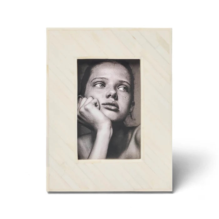 The Osage Photo Frame 4x6. This striking design is handcrafted from bone inlaid in a diagonal pattern.
