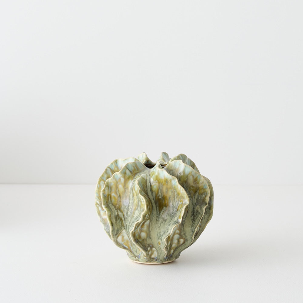 Green ceramic vase with textured surface 