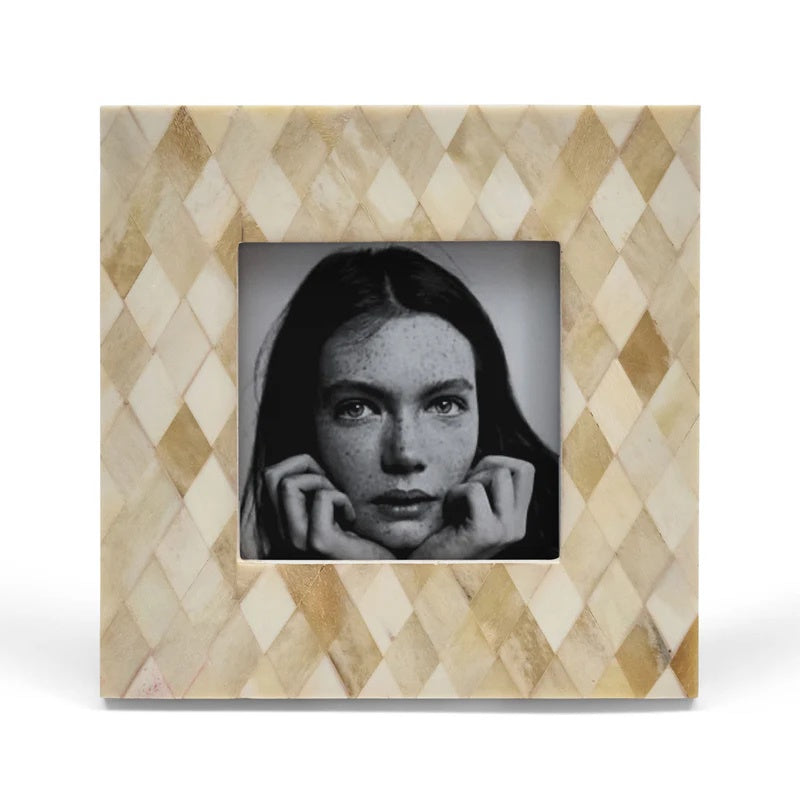 Decorative photo frame with a geometric pattern containing a black and white portrait.