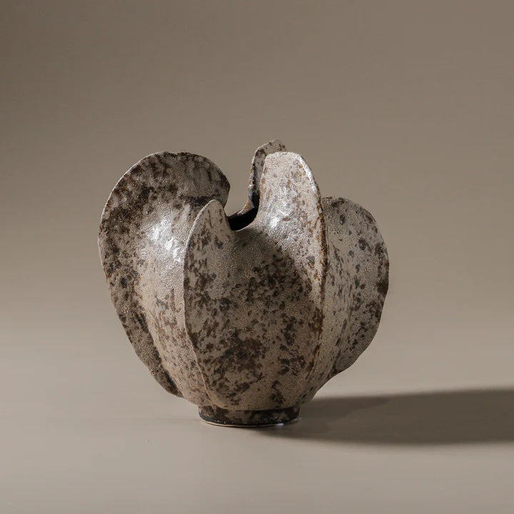 Abstract ceramic sculpture with mottled texture and neutral tone glaze.