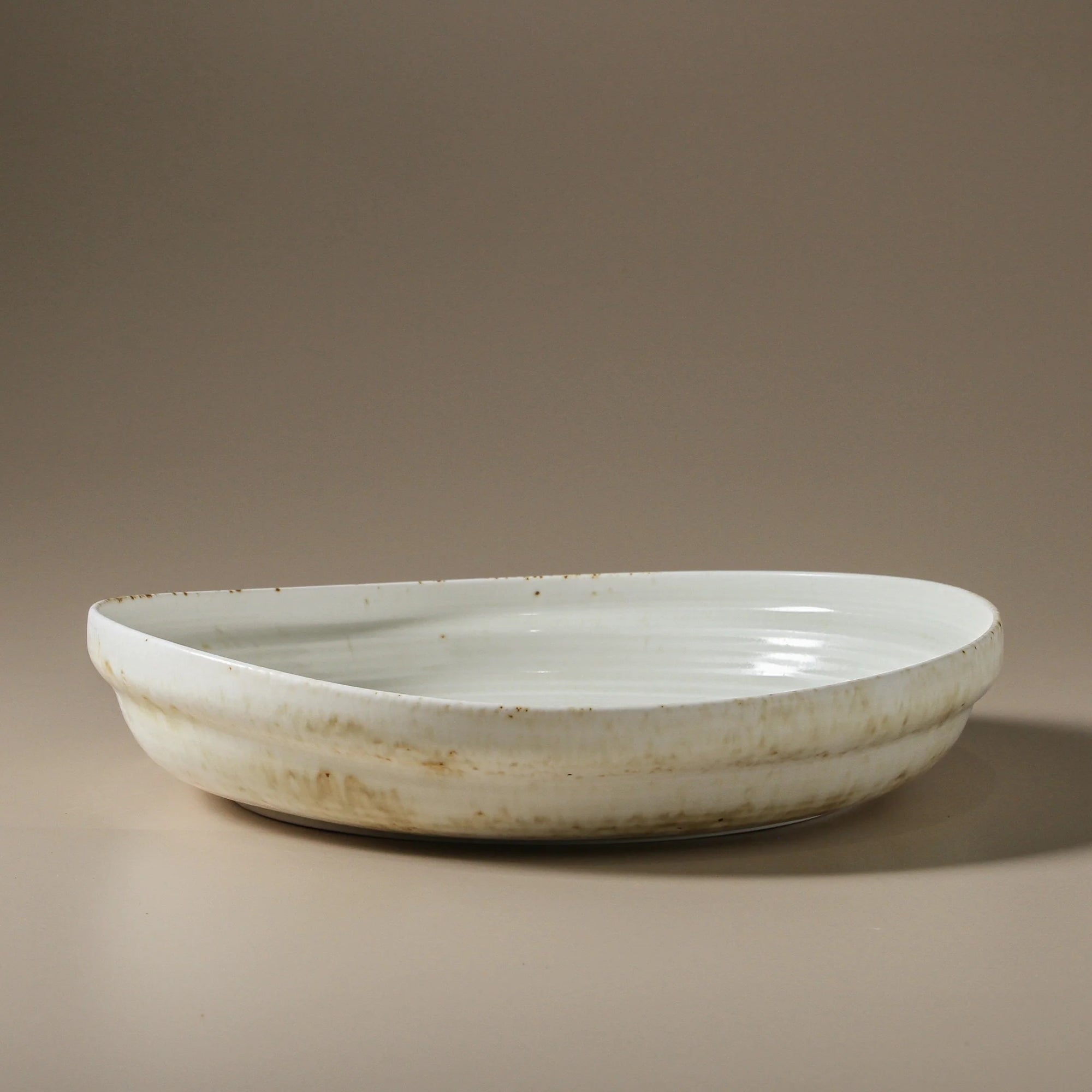 Large White and neutral ceramic bowl .