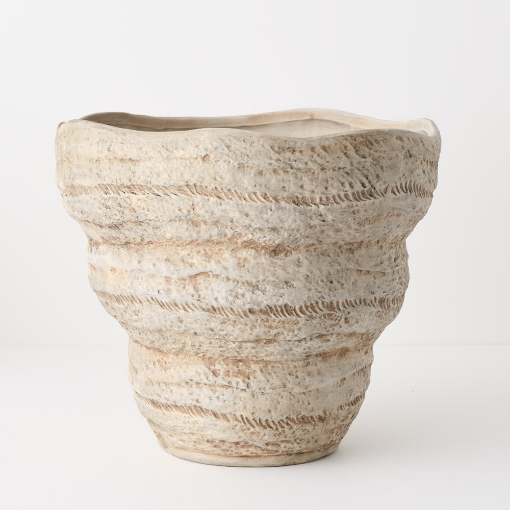 Textured ceramic planter in a natural beige colour. Wide opening and tapers to the base.