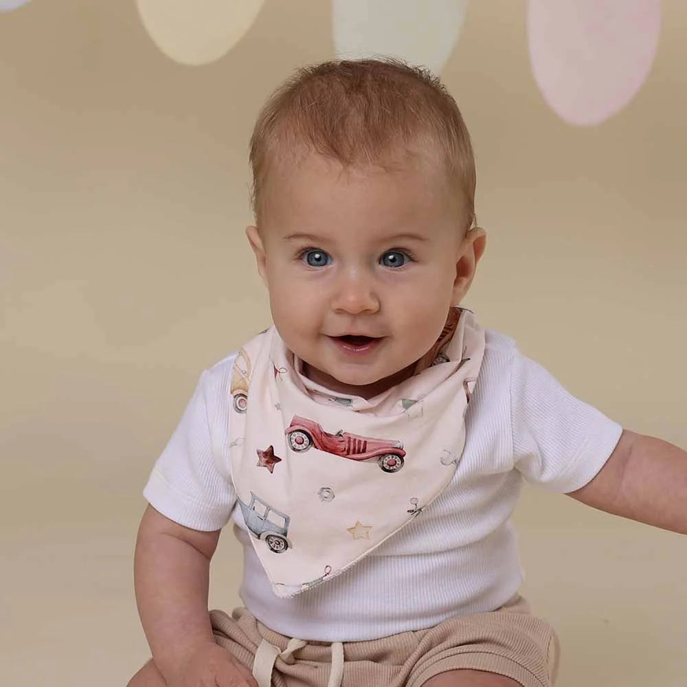 dribble bib with vintage car print design n a beige background