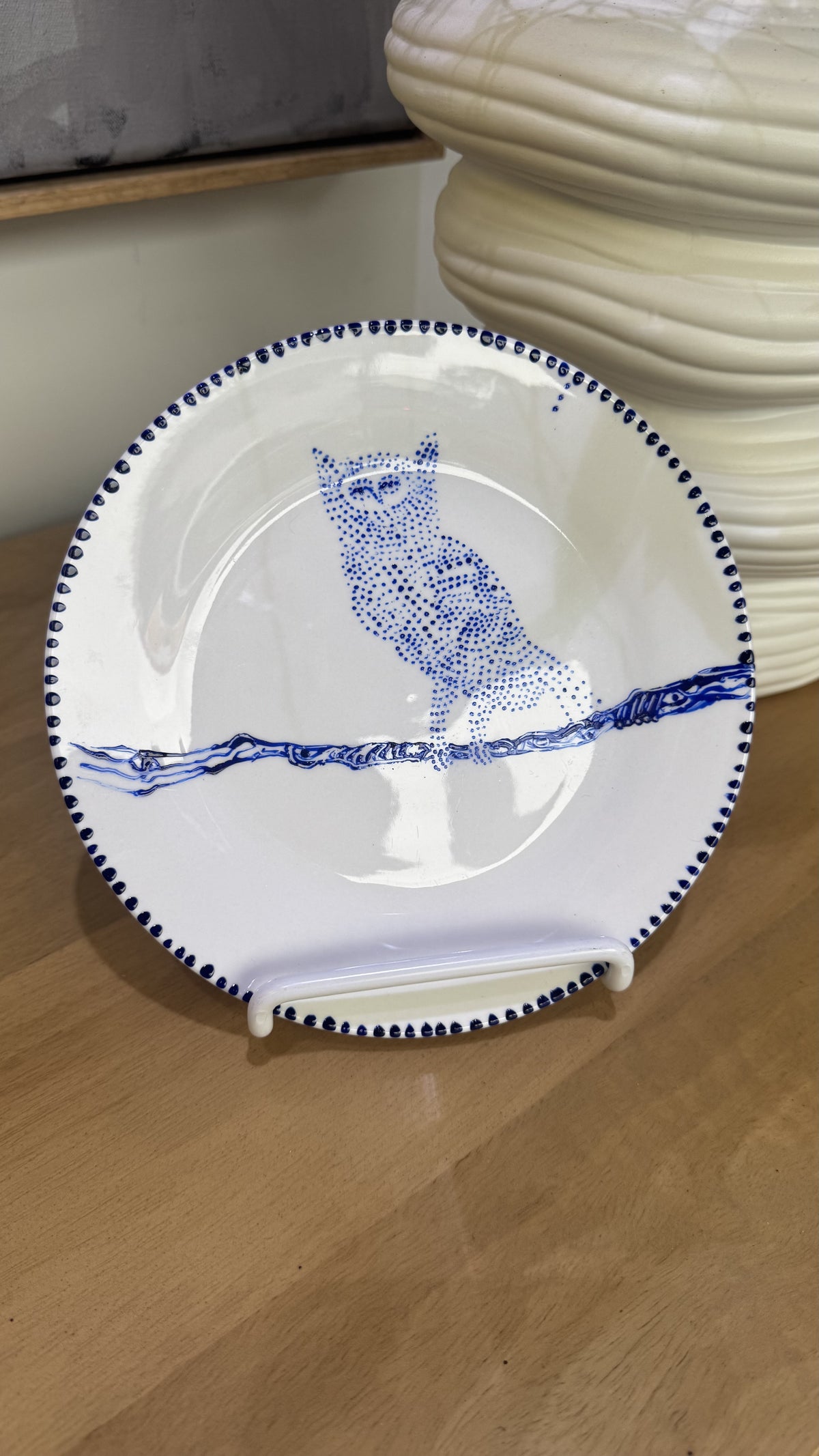 ceramic wall plate featuring blue cosmic owl by artist Nadia Robertson
