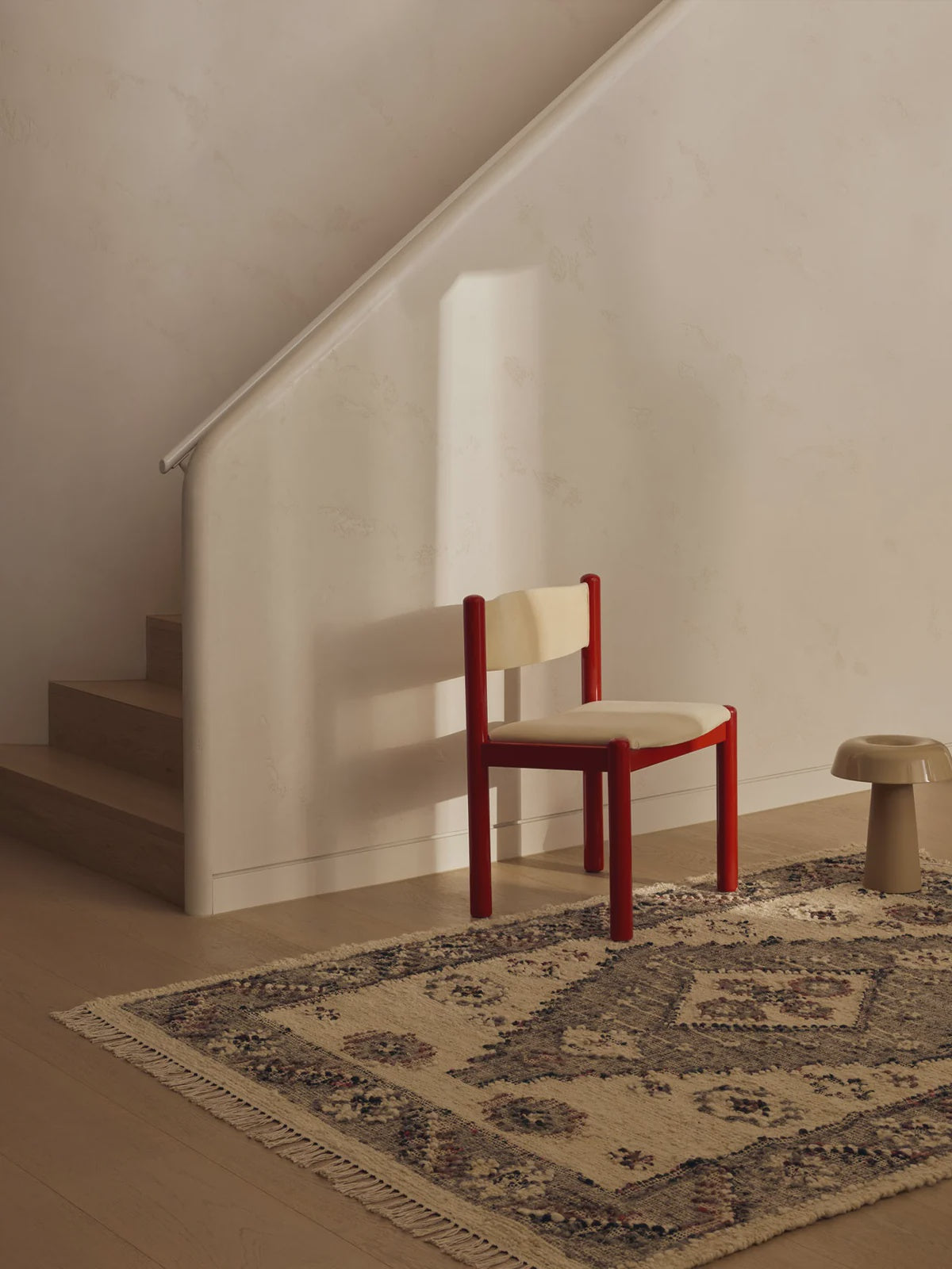 Tribe home ellora rug centred on a single diamond motif and softened by clusters of textured florets in cerise and soft grey.
