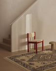 Tribe home ellora rug centred on a single diamond motif and softened by clusters of textured florets in cerise and soft grey.