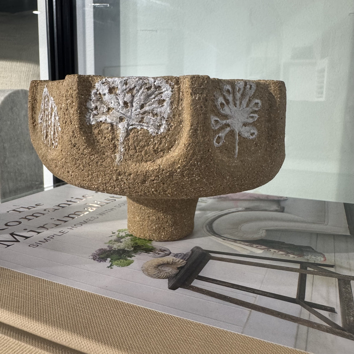 terracotta bowl with white floral herb design