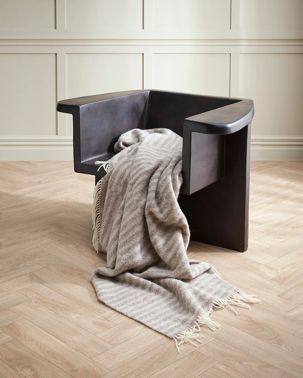 neutral striped blanket with white fringe
