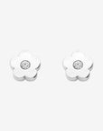 Flower-shaped silver earrings with clear gemstones on a white background